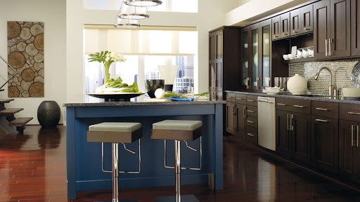 23. DARK WOOD CABINETS WITH A BLUE KITCHEN ISLAND